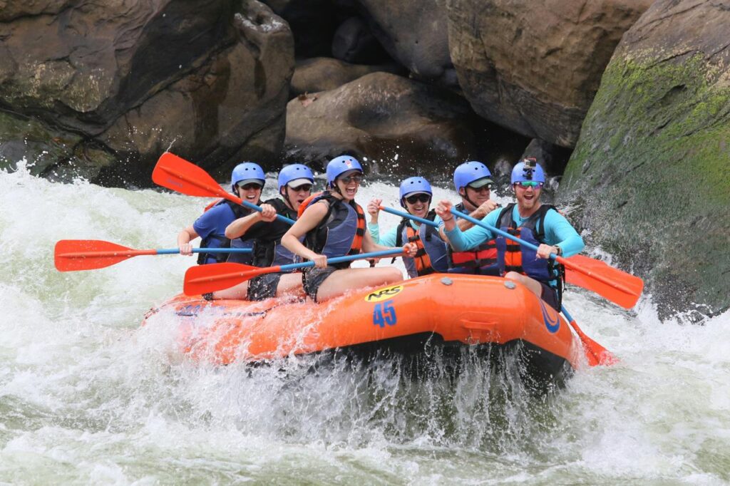 Group of tourists river rafting on Teesta River during Raft and Ridge Adventure tour near Darjeeling